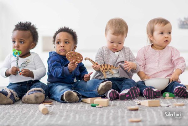 Group of babies playing. Learn about baby safety tips during Baby Safety Month at Safer Lock.